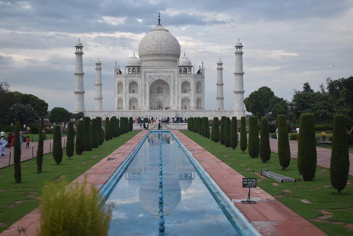The Taj Mahal mirrored in the central reflecting pool at first light