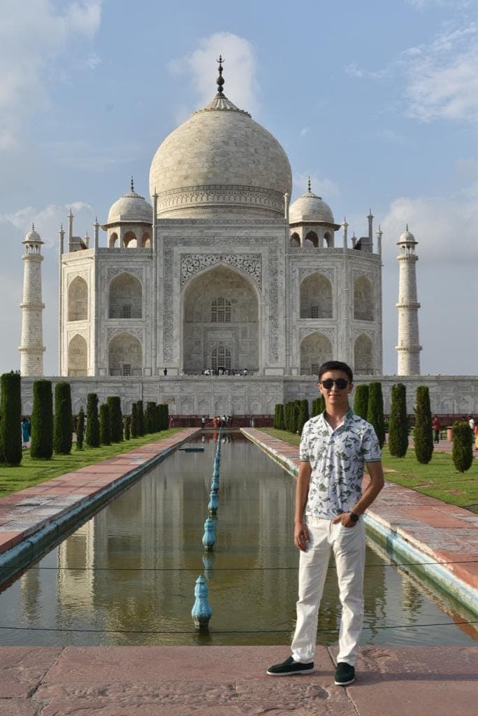 A couple photographed on the marble plinth of the Taj Mahal in early morning light