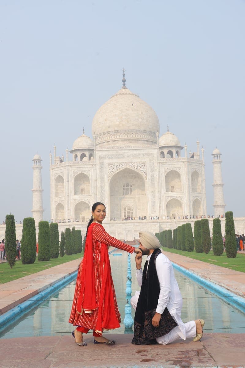 The Taj Mahal seen through a side arch of the mosque at dawn