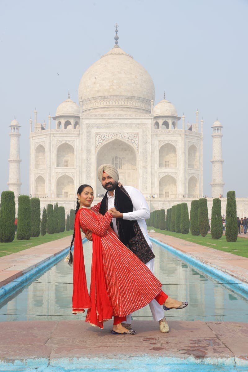 A couple photographed on the marble platform at the Taj Mahal